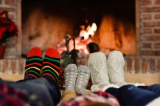 A group of people sitting in front of a fire.