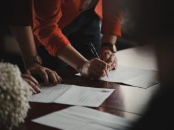 A person signing papers on renting a NYC storage unit